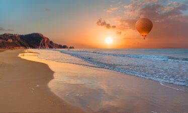 Hot air balloon flying over Agadir at sunrise